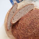Artisan looking buckwheat bread with two slices next to it