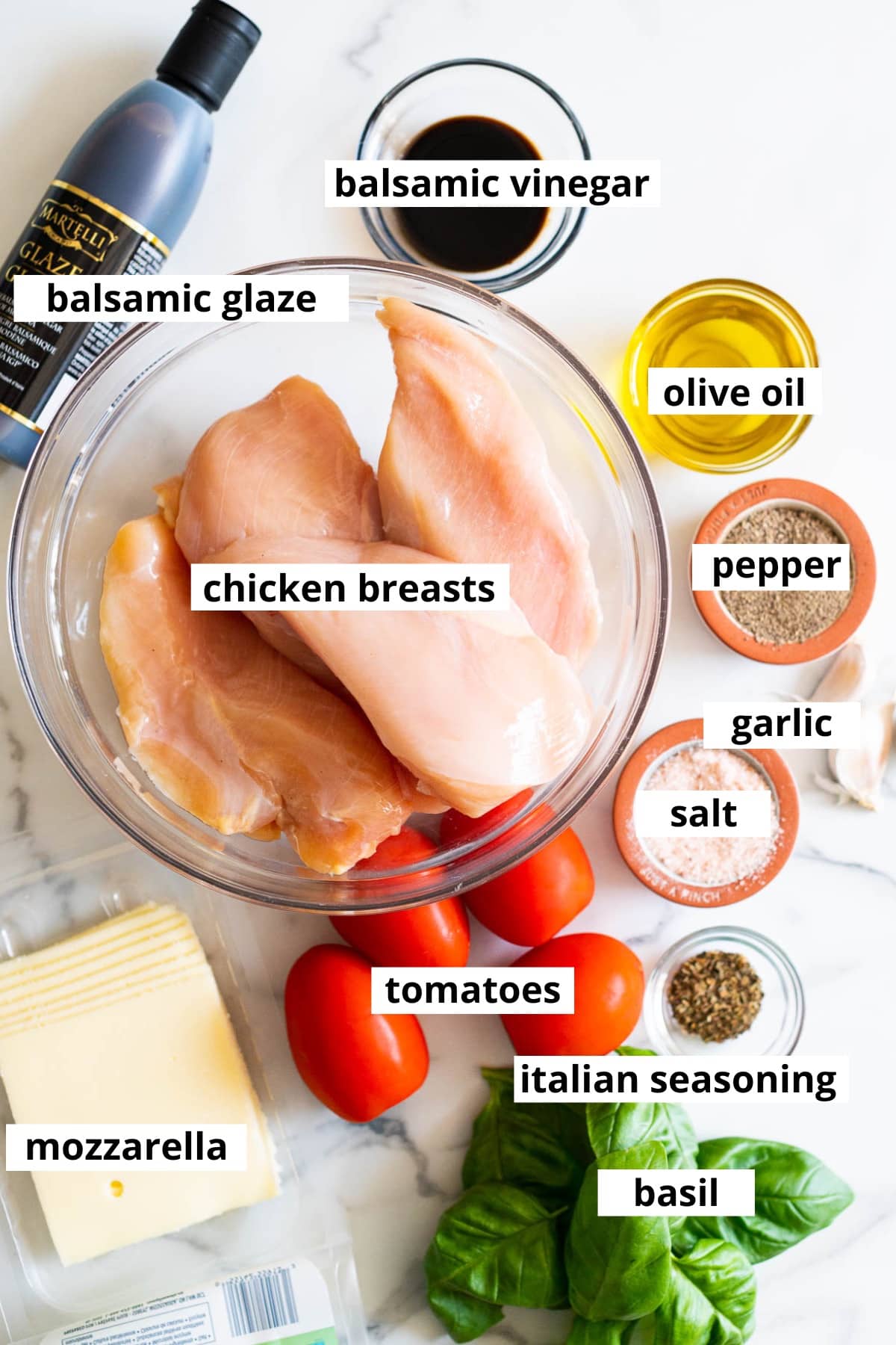 Chicken breasts, balsamic vinegar, balsamic glaze, olive oil, garlic, salt, pepper, tomatoes, mozzarella cheese, Italian seasoning, basil.